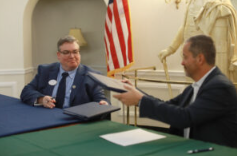 UMW Provost Timothy O’Donnell (left) and George Mason University Provost James Antony complete the official signing at a ceremony that reconfirmed a partnership between the two schools for an accelerated degree pathway program in computer science, engineering and law. Photo by Karen Pearlman.